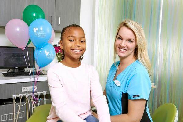Image of a dental assistant with a happy patient